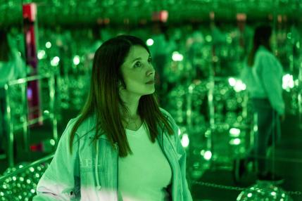 DeJa Vu Museum - Woman in room with green lights