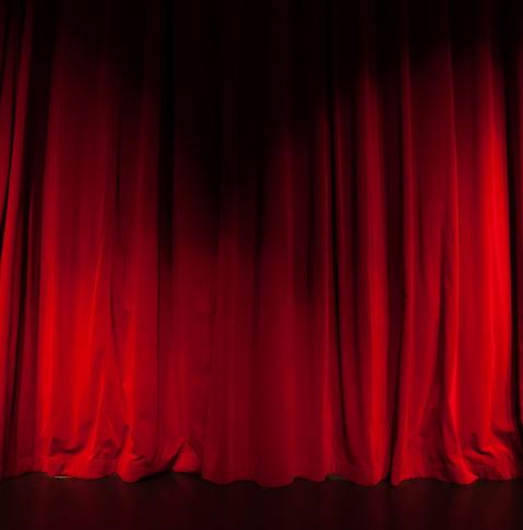Curtain from the theatre with a spotlight as background